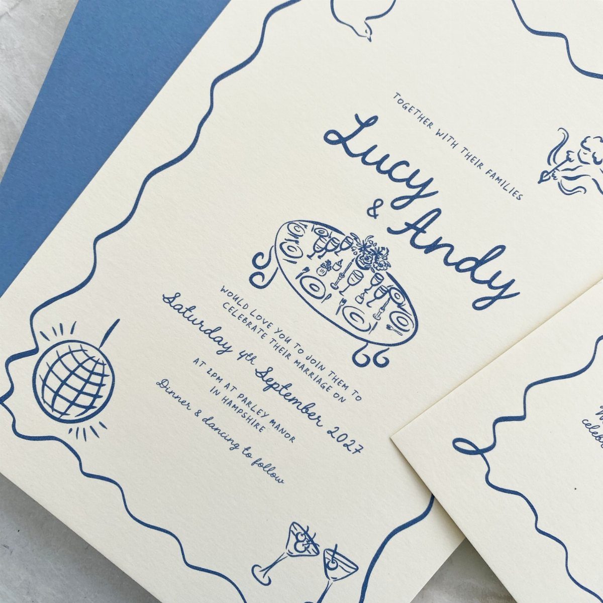 Wedding invitation with blue hand-drawn doodles of a dinner table and disco ball.