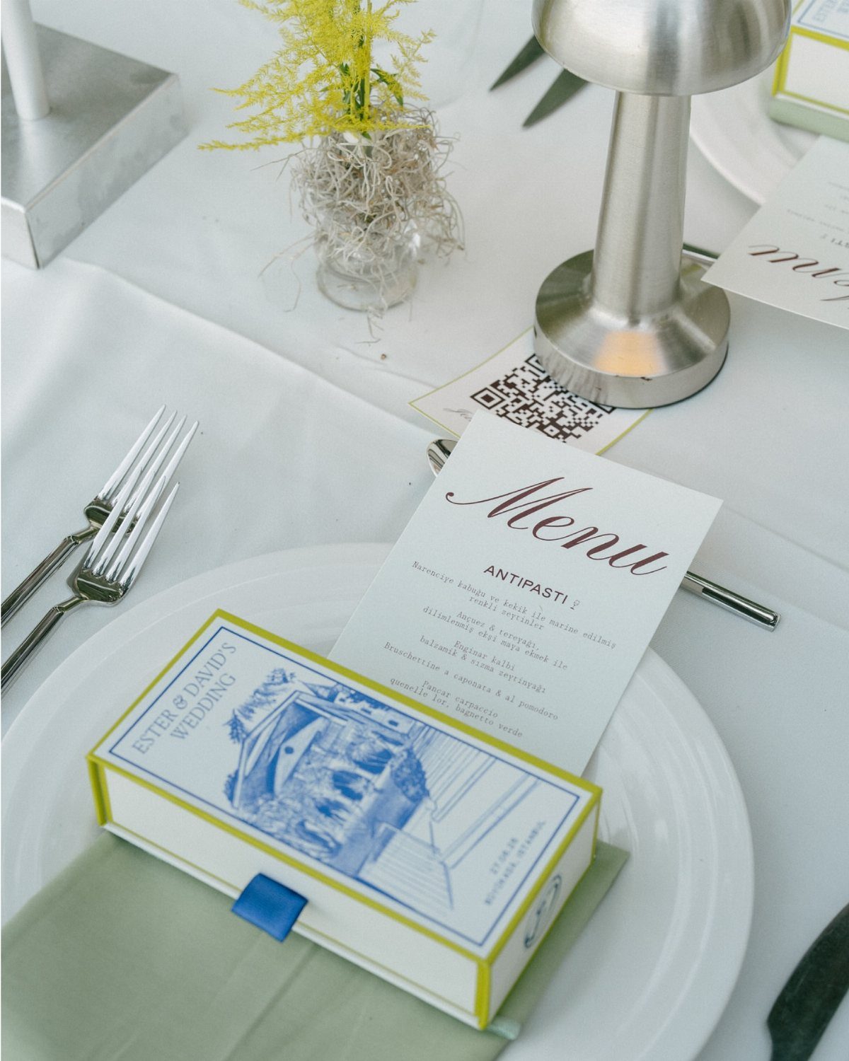 Wedding table setting with a custom illustrated gift box and printed menu card.