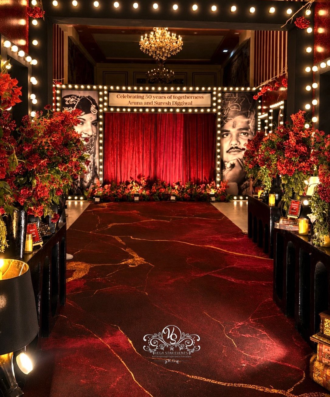 Red carpet entrance for a 50th wedding anniversary party with portraits and flowers