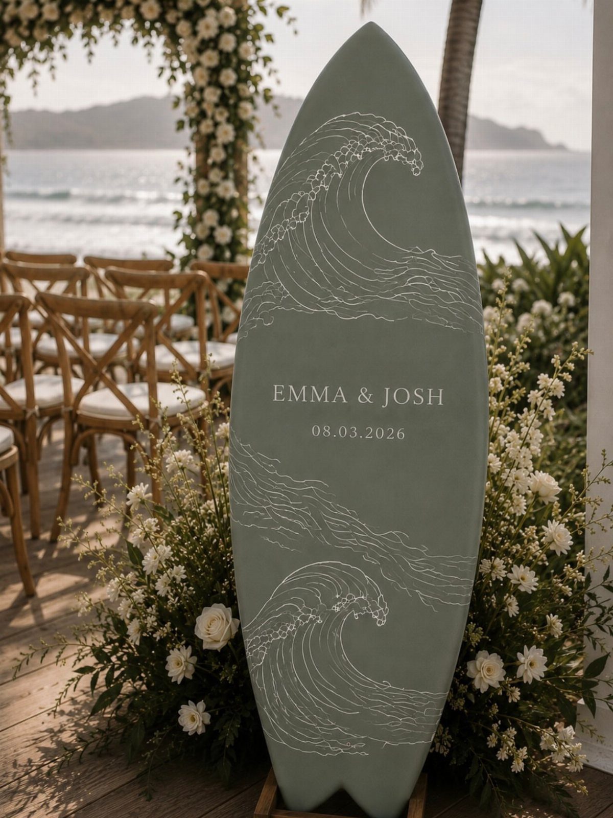 Sage green surfboard wedding sign with names and waves on a beach deck