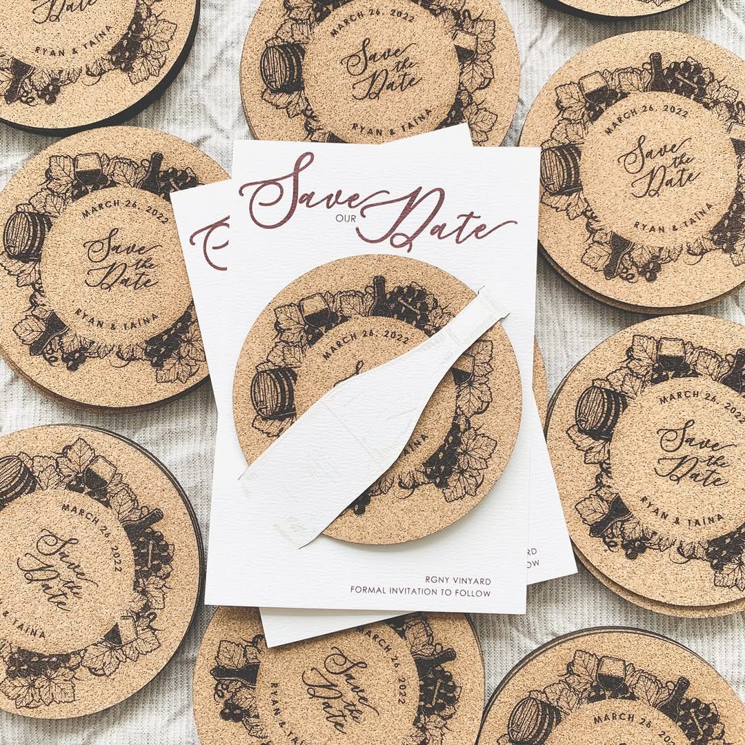 Round cork coasters with wine-themed illustrations and a Save the Date card.