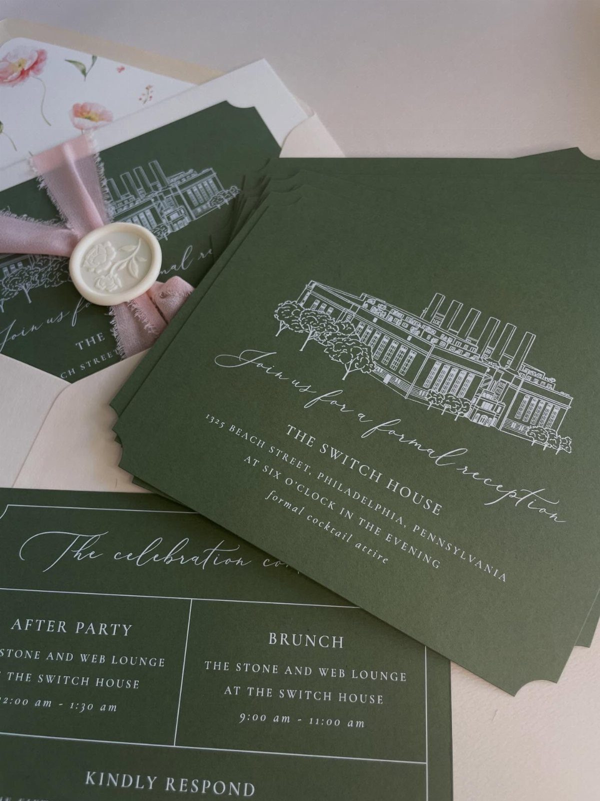 Dark green wedding invitations with white ink and a scalloped die-cut bottom edge.