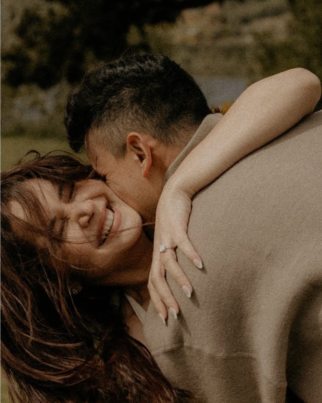 Couple embracing in a heartfelt hug with the man kissing the woman's cheek.