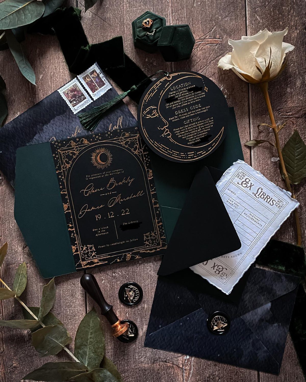 Dark green and black wedding invitation suite with gold foil and wax seals.