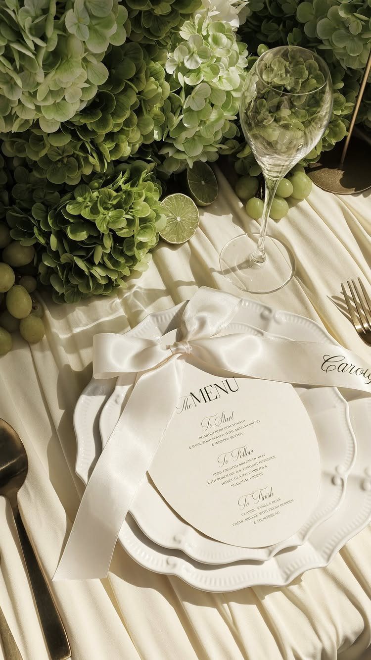 Circular wedding menu card with elegant typography on a white plate with ribbon.