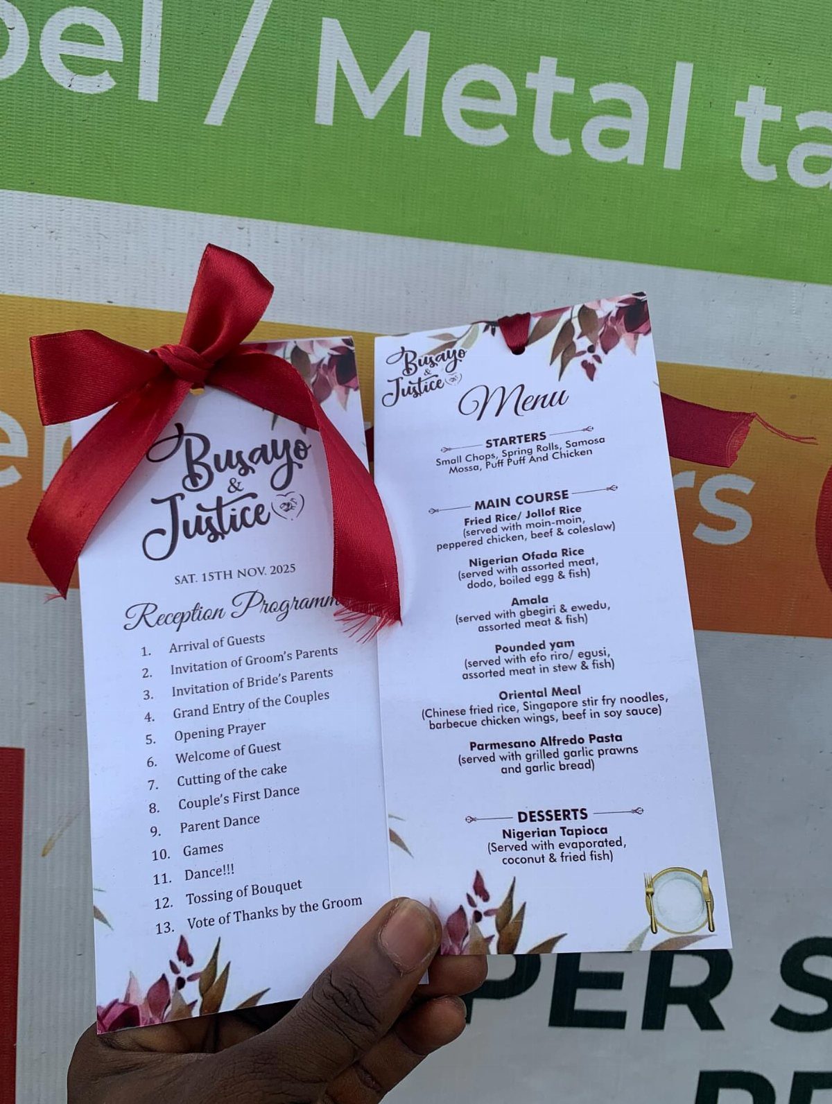 Wedding reception program and menu cards with red floral accents and a red bow.