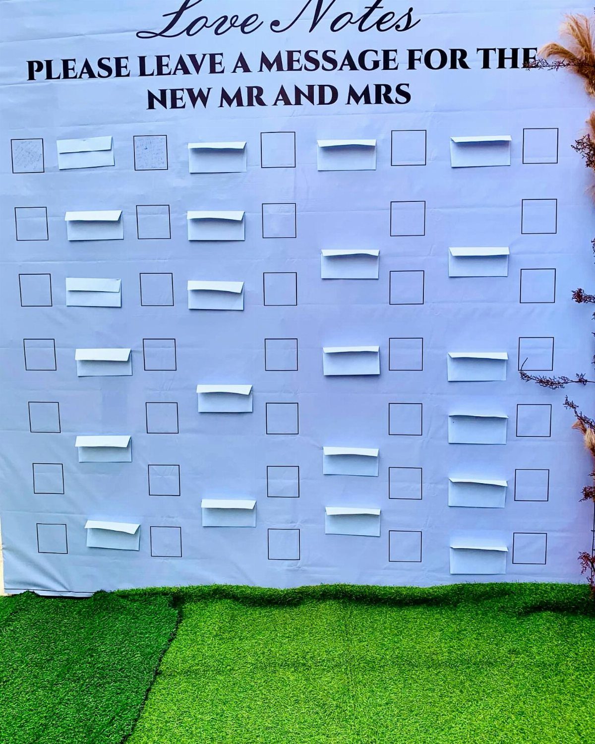 White backdrop with pockets for love notes messages for a new couple.