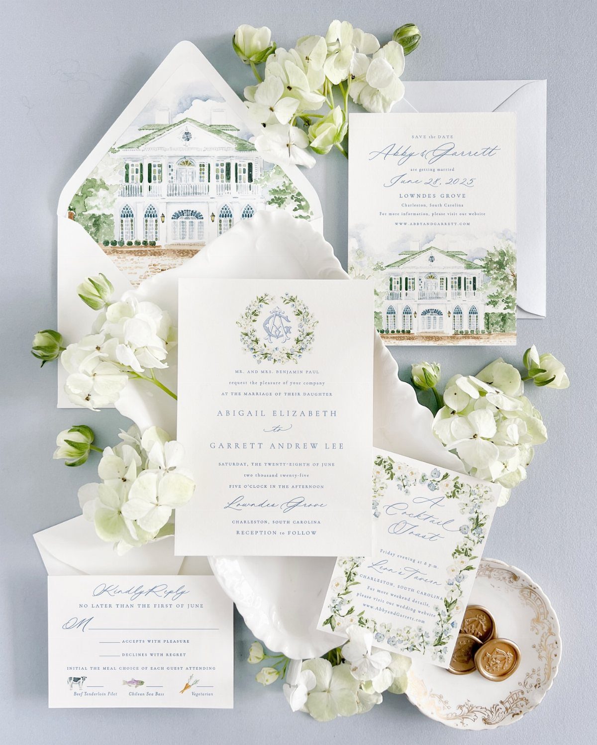 Wedding invitation suite featuring watercolor illustrations of a white manor house and flowers.