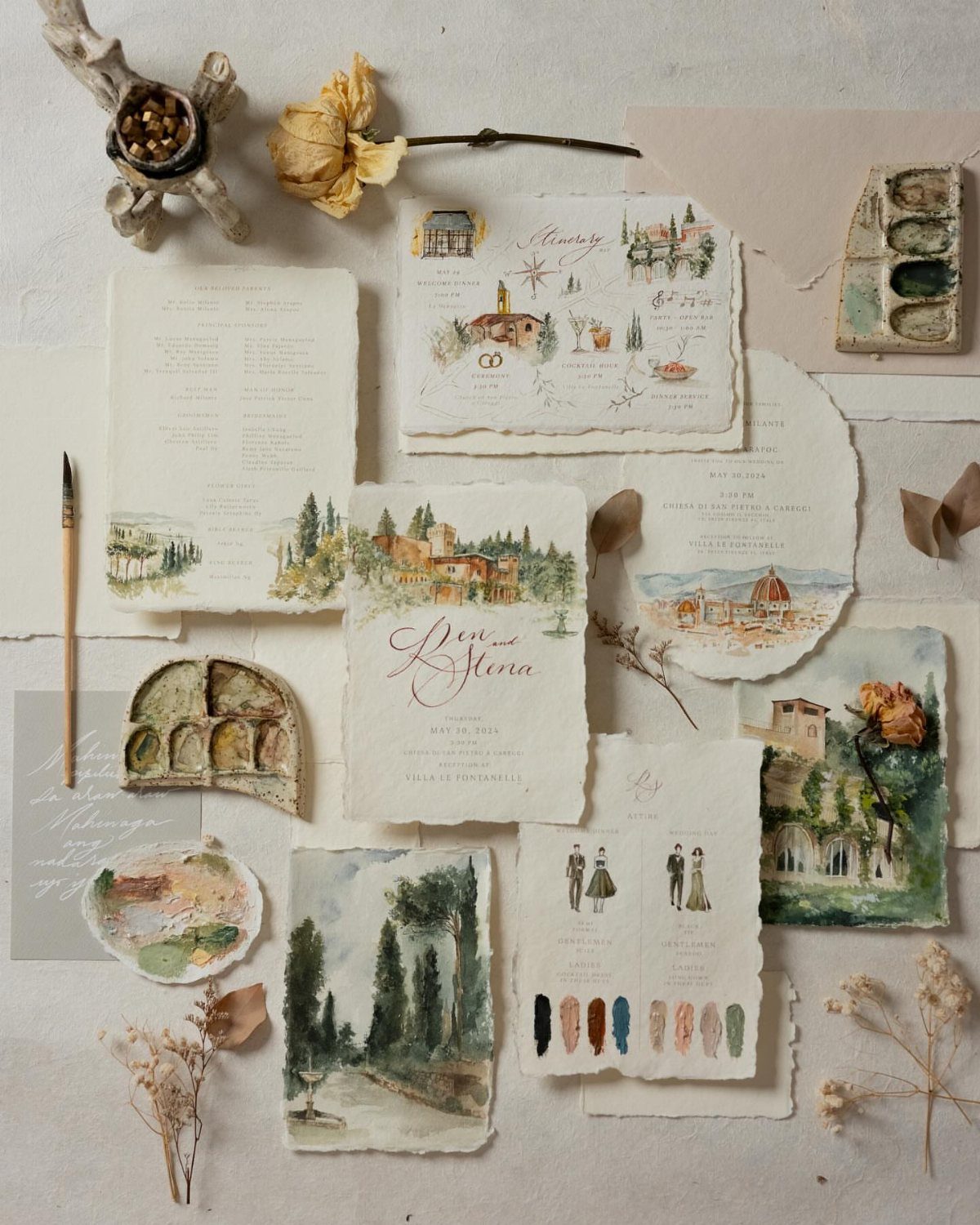 Hand painted wedding invitations with watercolor European landscapes and classical figures on deckle-edge paper.