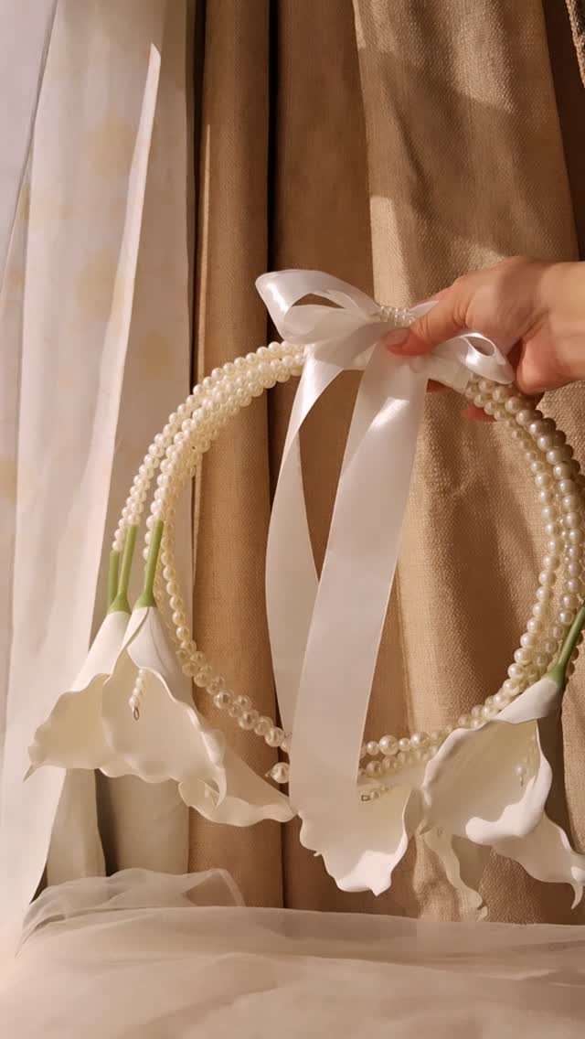 Pearl decorated wedding hoop with white calla lilies and a satin ribbon bow.