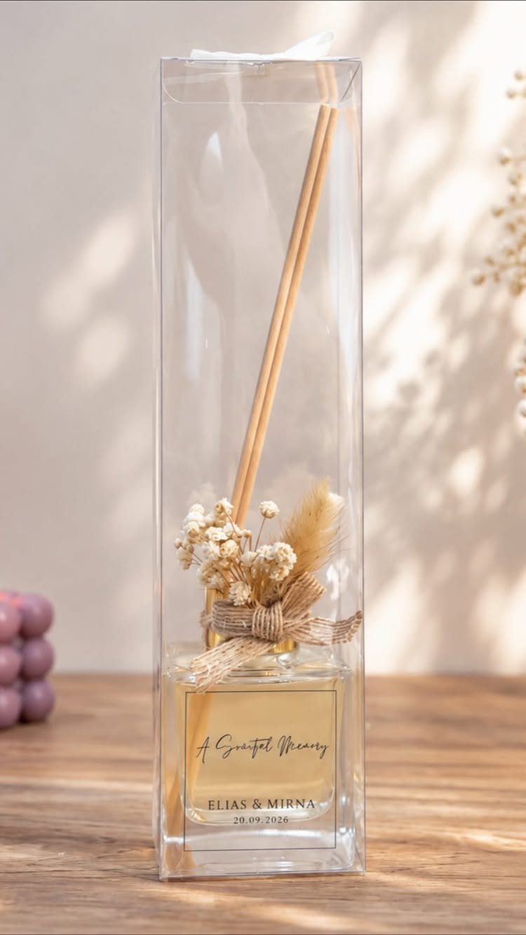 Reed diffuser gift in clear packaging with dried flowers and personalized gold label.