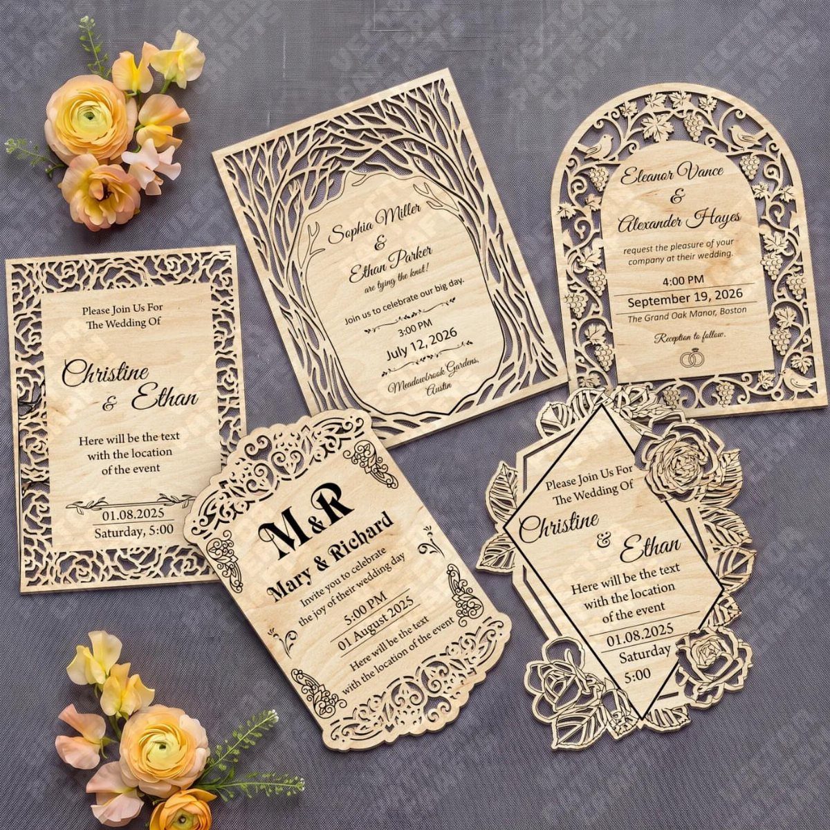 Laser-cut wooden wedding invitations with intricate patterns arranged on a grey textured background.