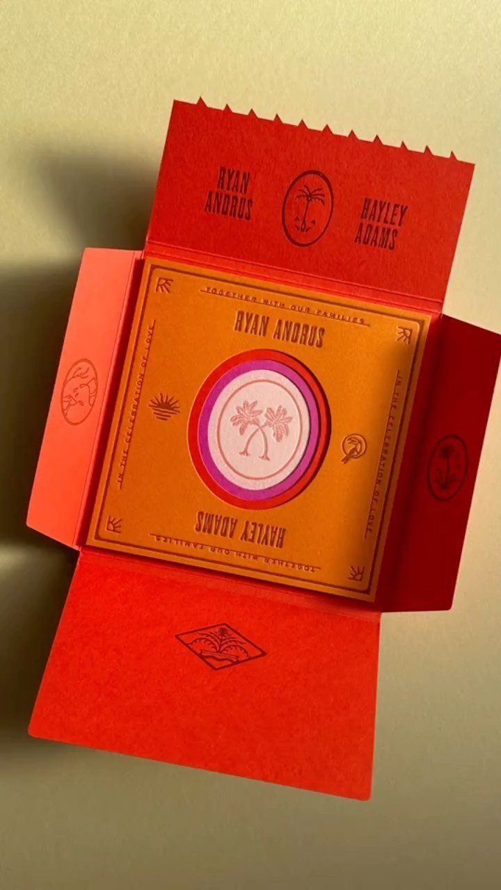 Mid century modern wedding invitation with orange and red colors and palm tree graphics.
