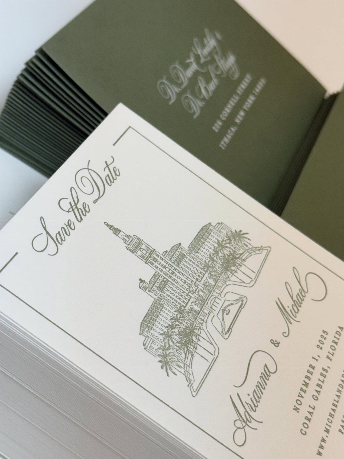 White save the date cards with green architectural line art and script typography.