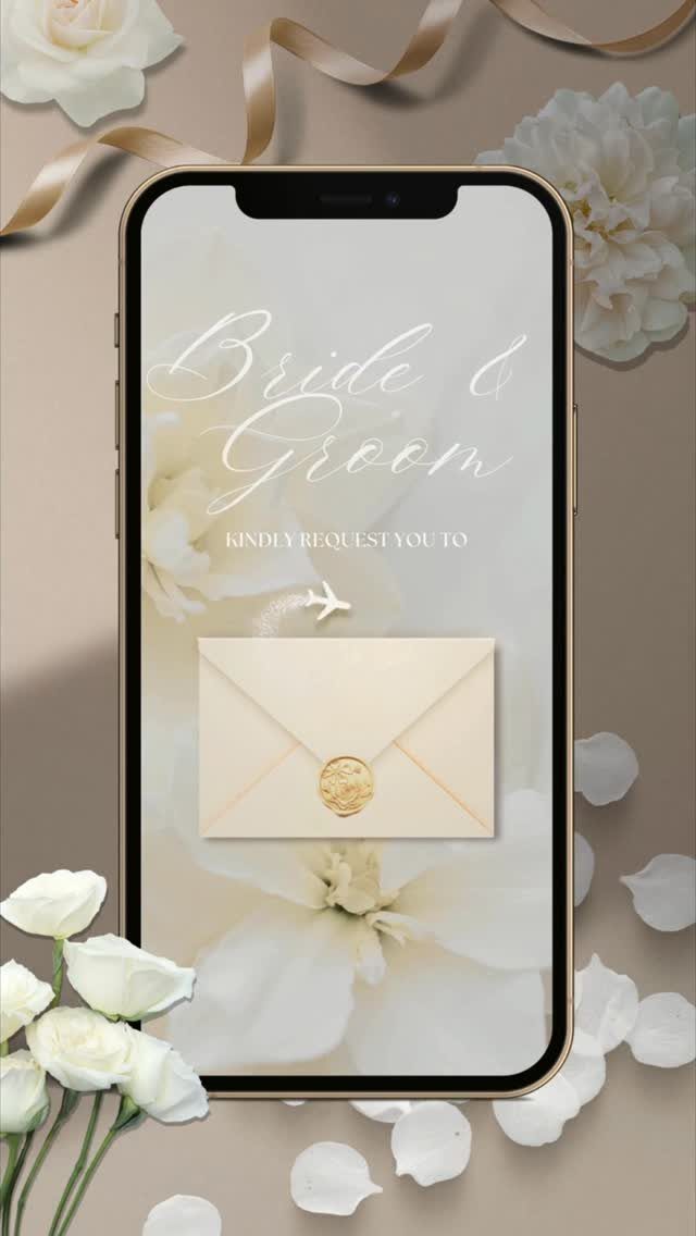 Smartphone displaying a digital wedding save the date invitation surrounded by white flowers.