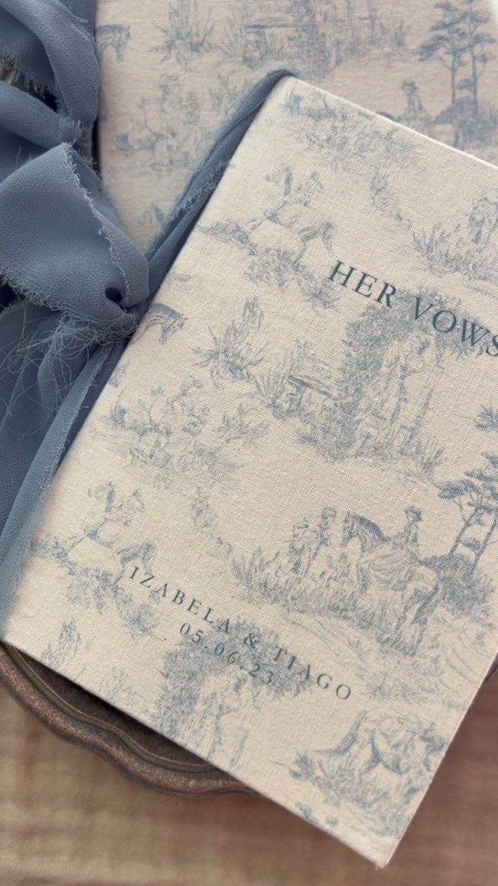 Personalized vow book with blue toile pattern and a light blue ribbon.