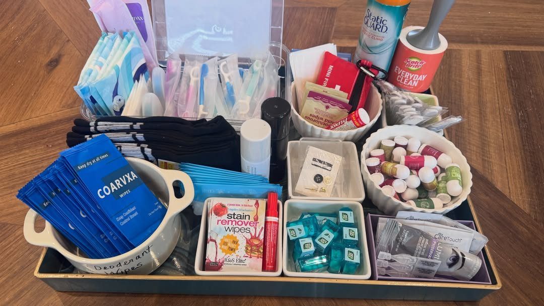 Emergency kit items on a gold tray including wipes, mints, and toiletries.