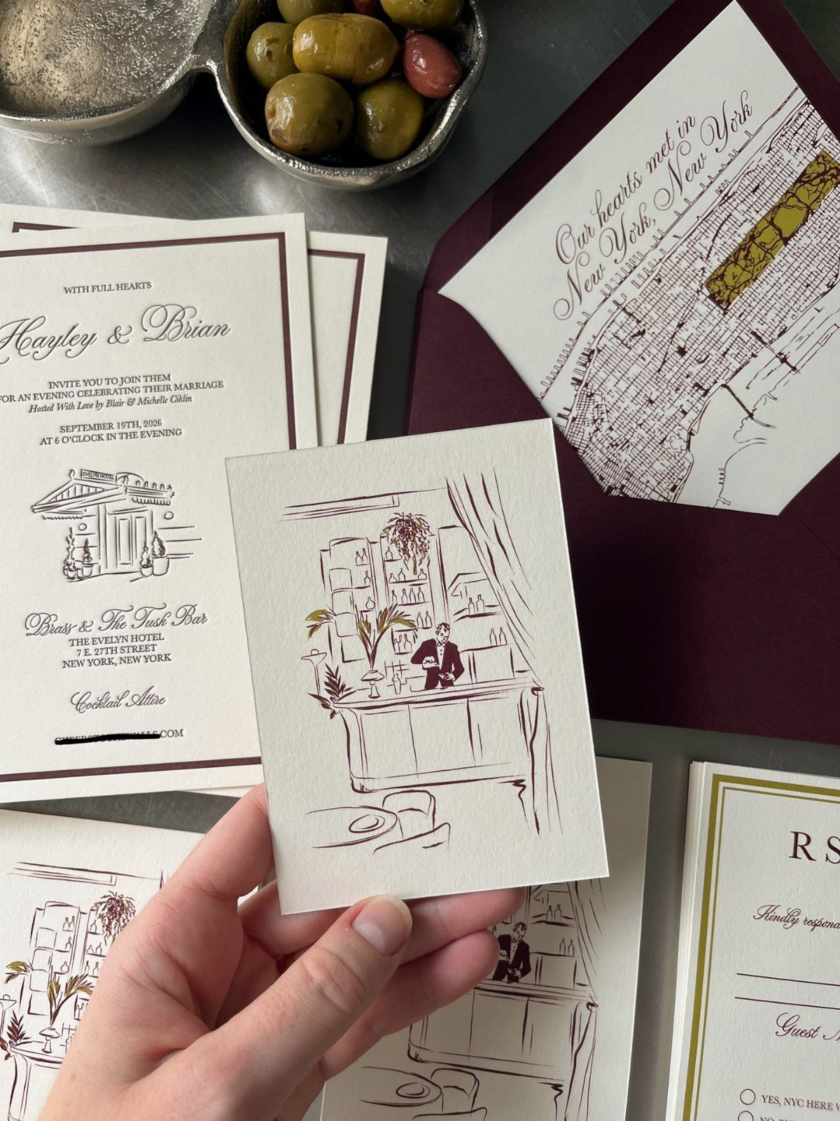 Wedding invitation samples including a custom illustration and a New York City map.