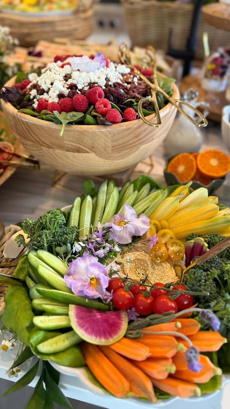 Fresh vegetable platter and berry salad in a wooden bowl for a party.