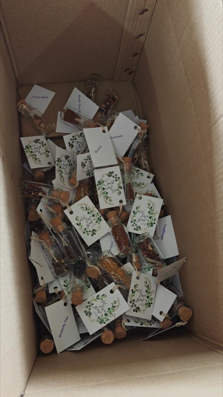 Small glass vials with corks and floral tags filled with dried herbs.