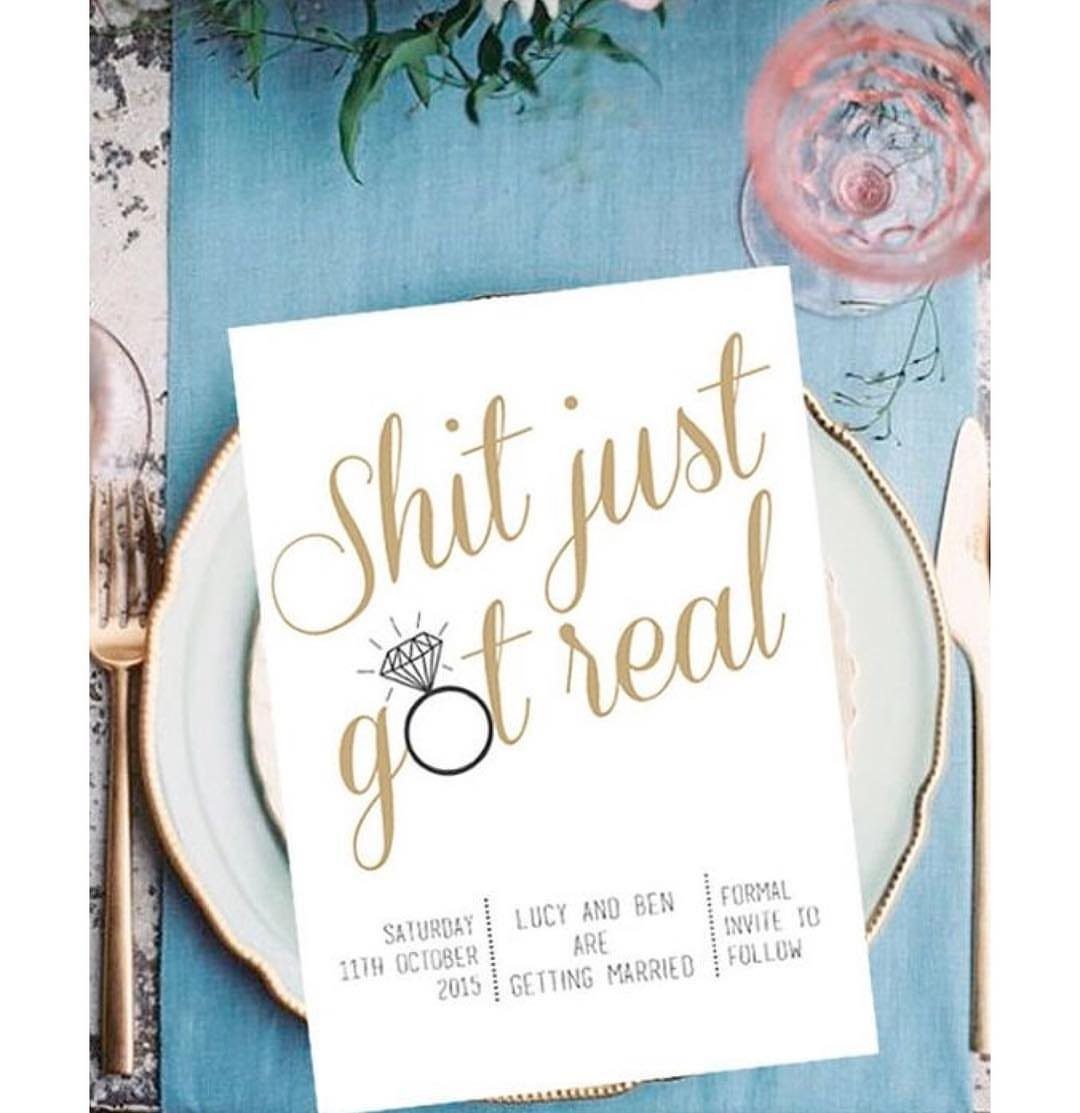White save the date card with humorous gold text on a blue dinner plate