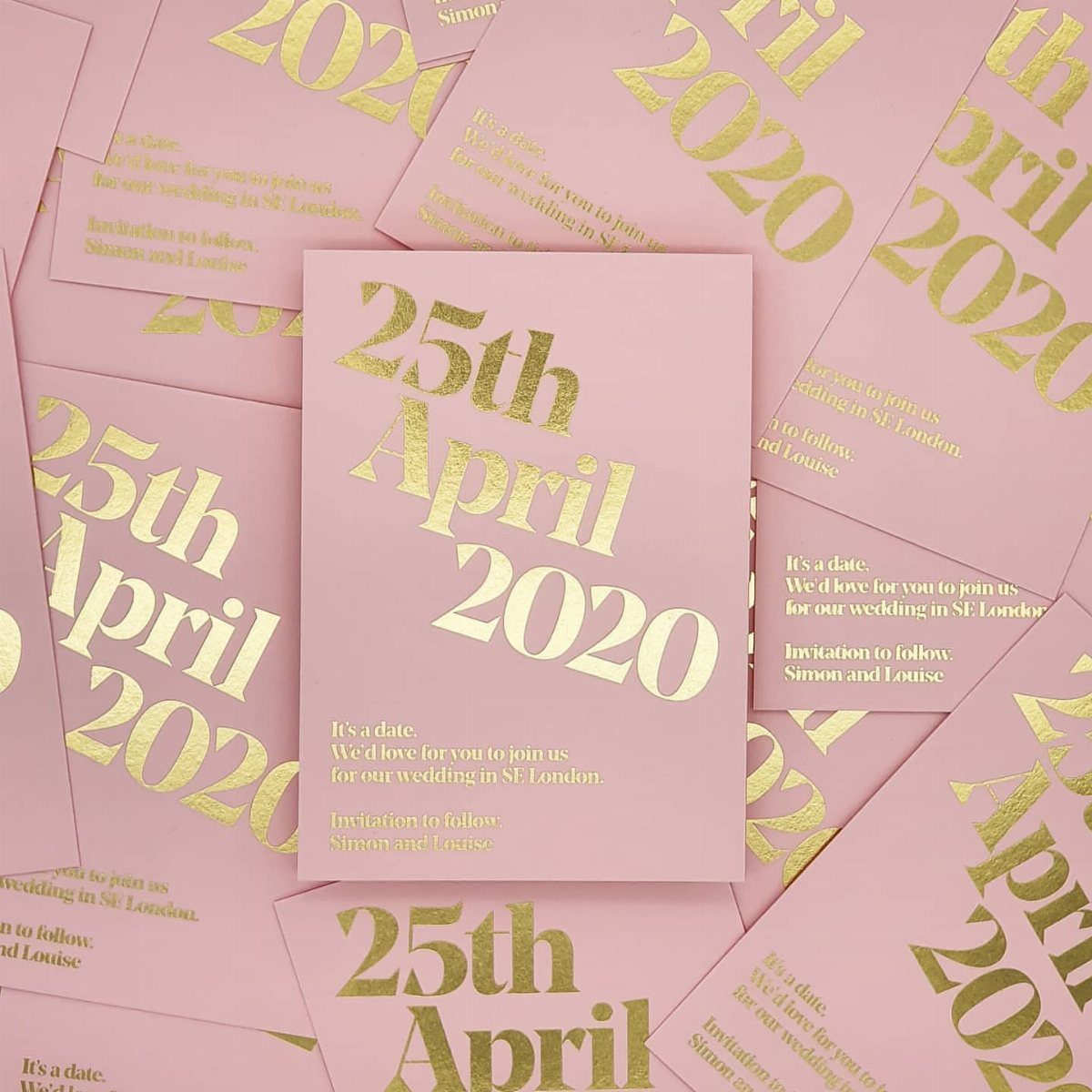 Pink save the date cards featuring elegant gold foil pressed wedding announcement text.