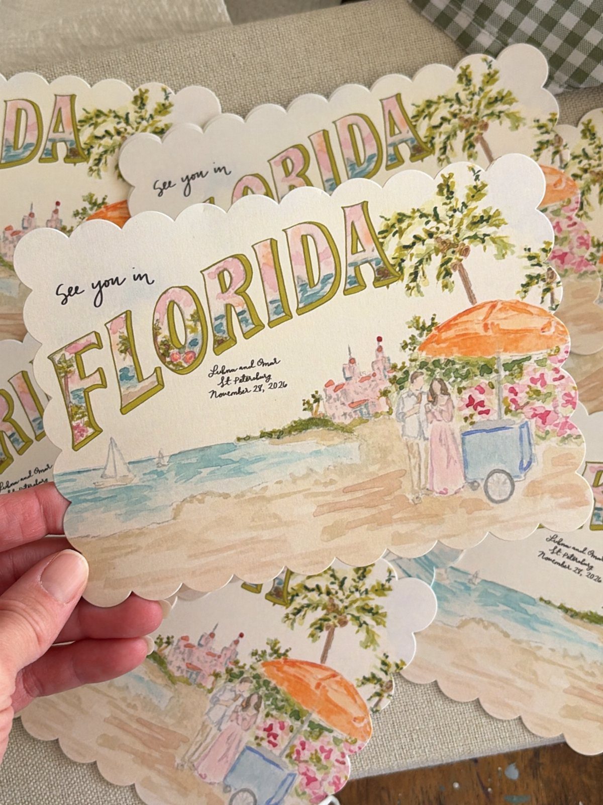 Watercolor illustrated save the date cards featuring a beach scene in Florida.