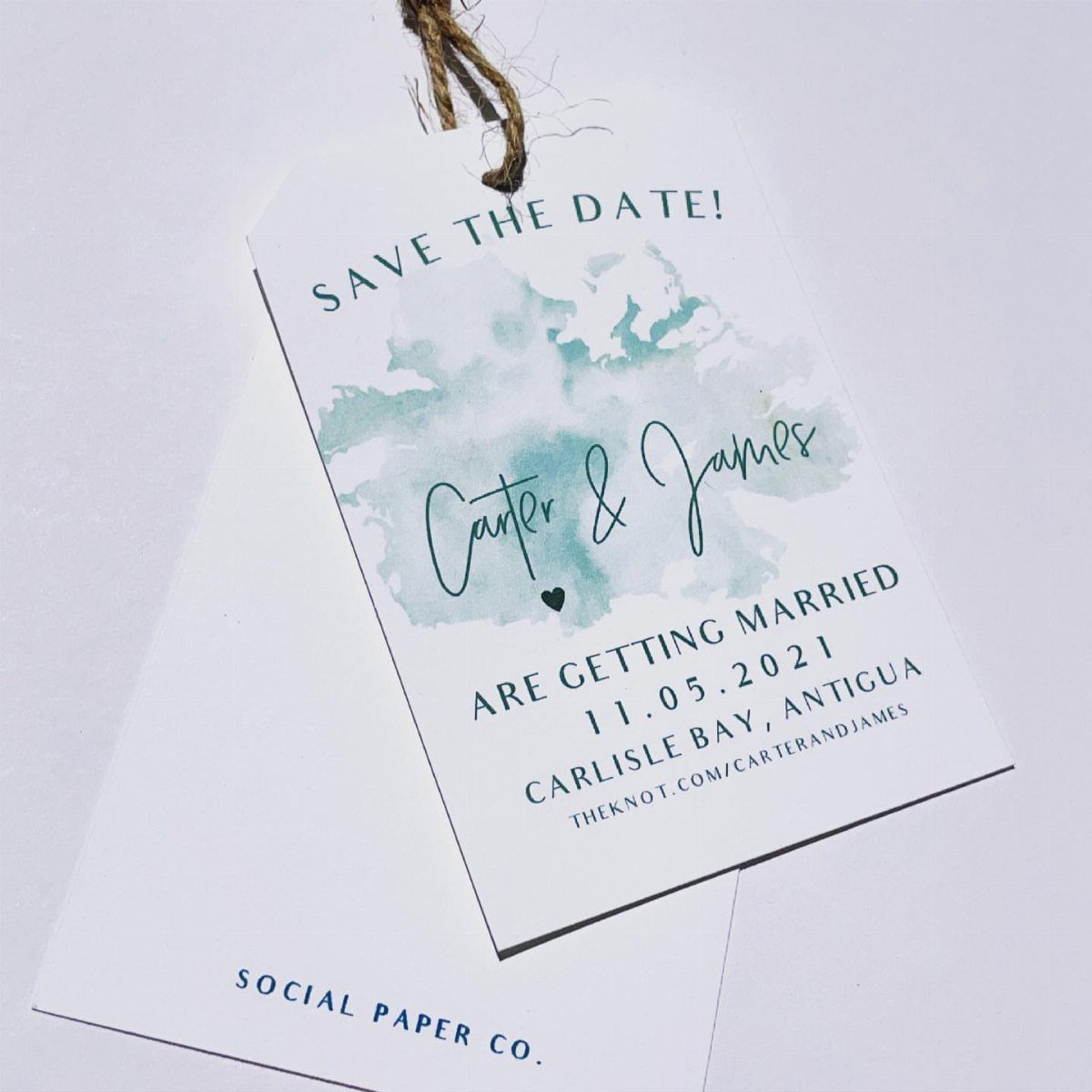 Luggage tag save the date card with teal watercolor and twine string.