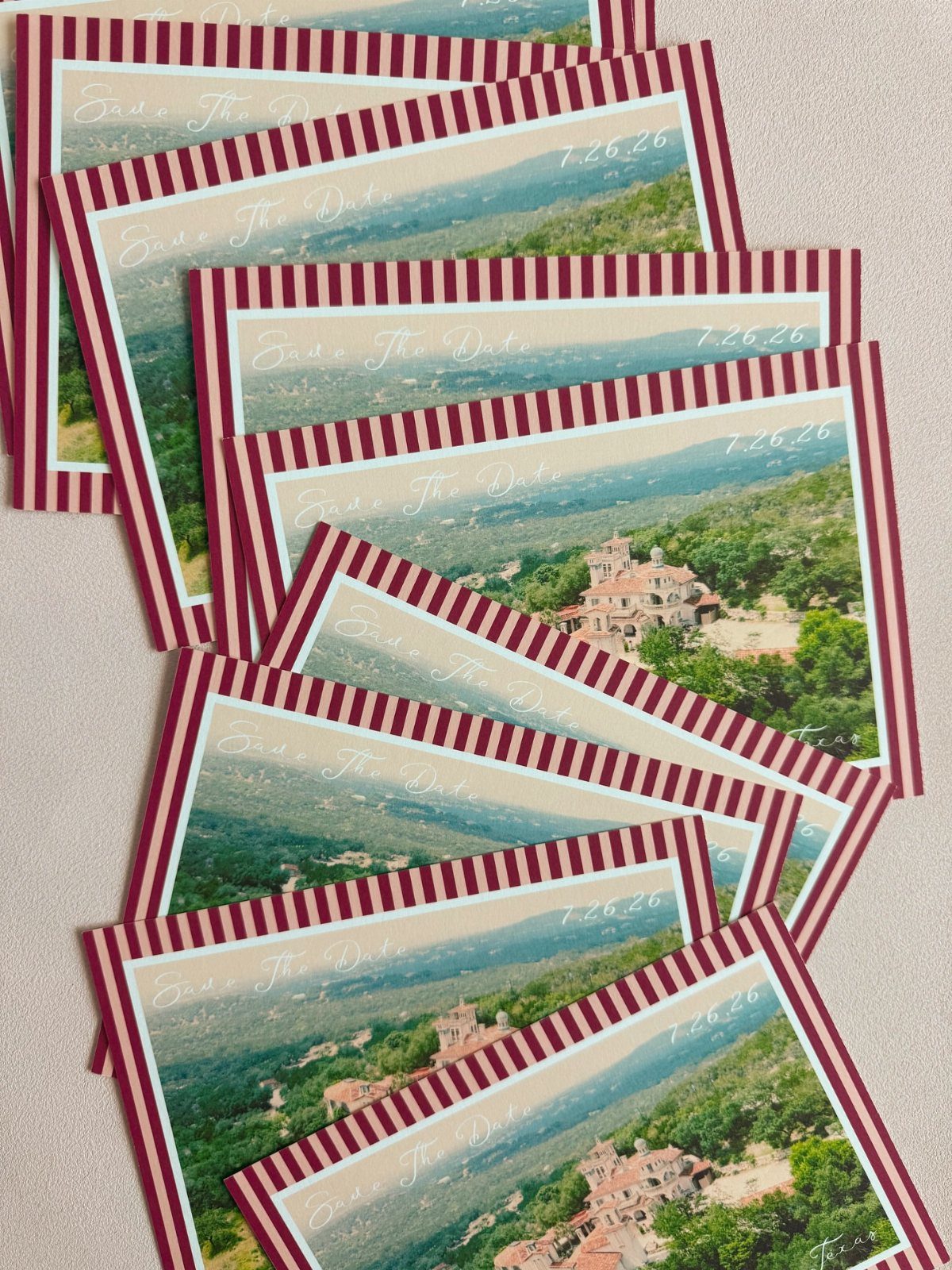 Save the date cards with red striped borders and a villa landscape photo.