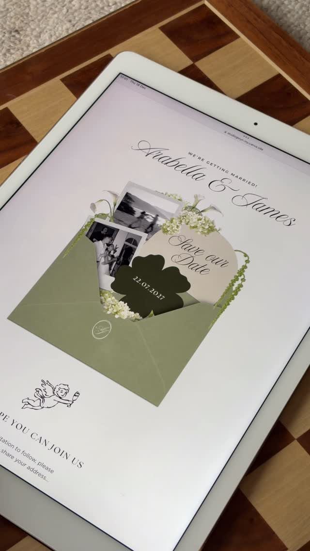 Digital save the date invitation on a tablet screen resting on a chessboard