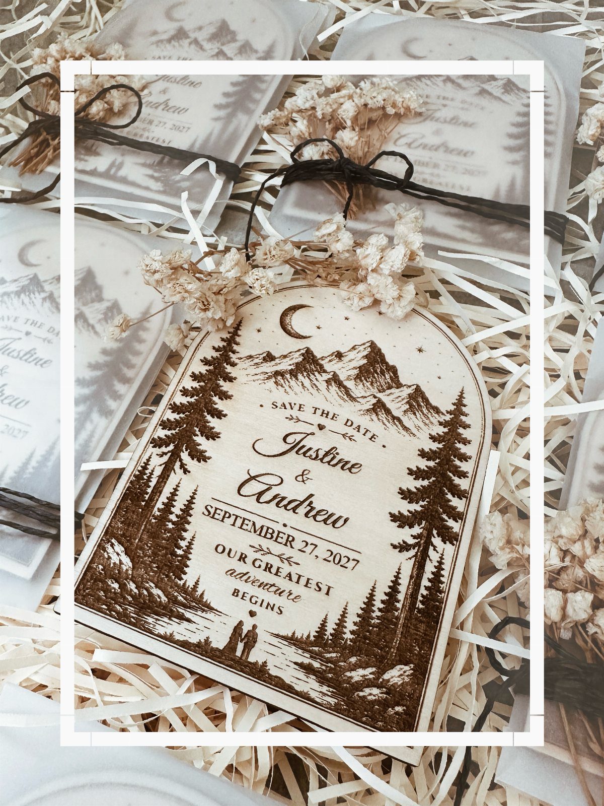Engraved wooden save the date card with mountain scenery and dried flower accents