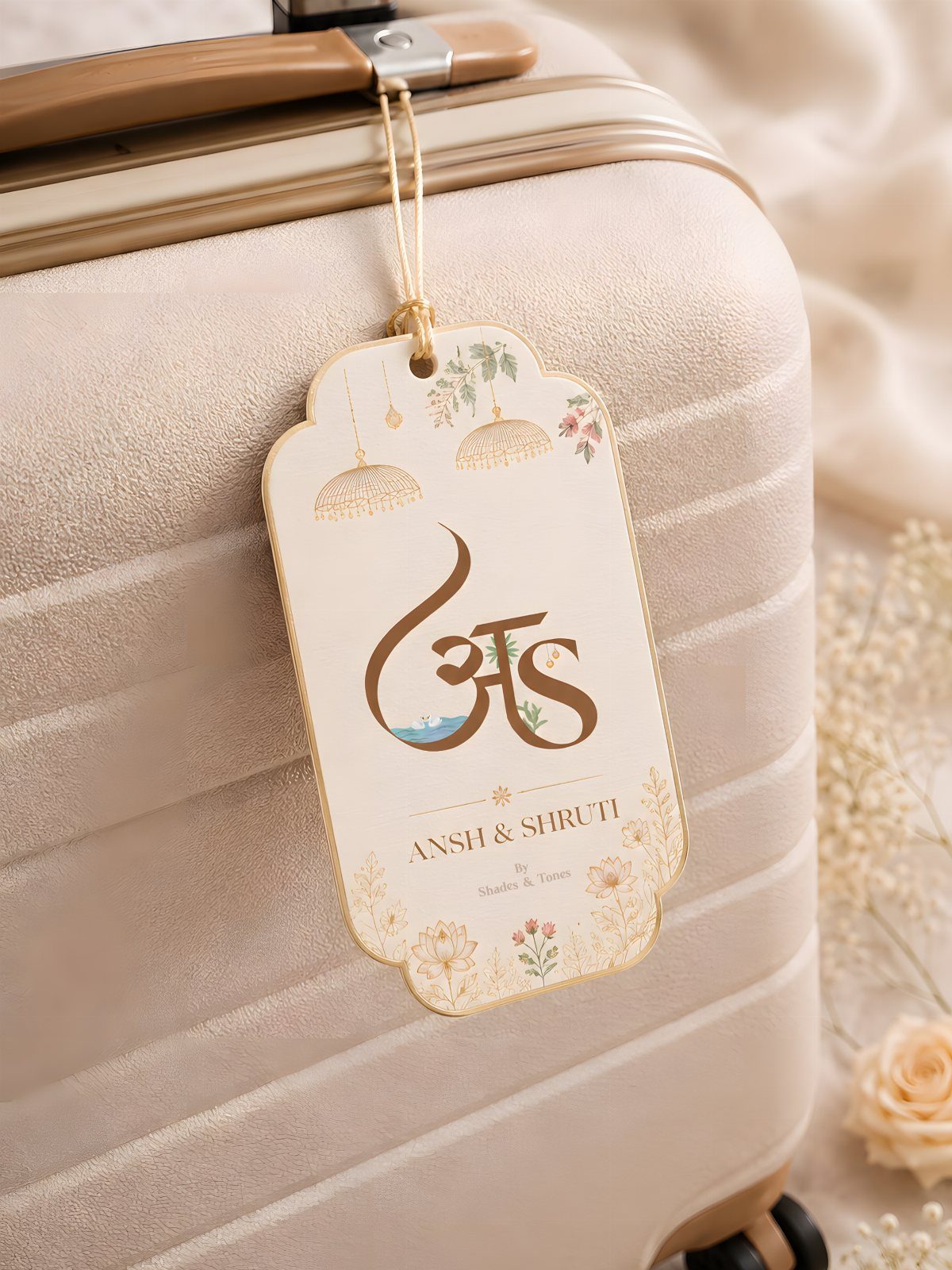 Custom luggage tag with floral designs attached to a beige suitcase handle