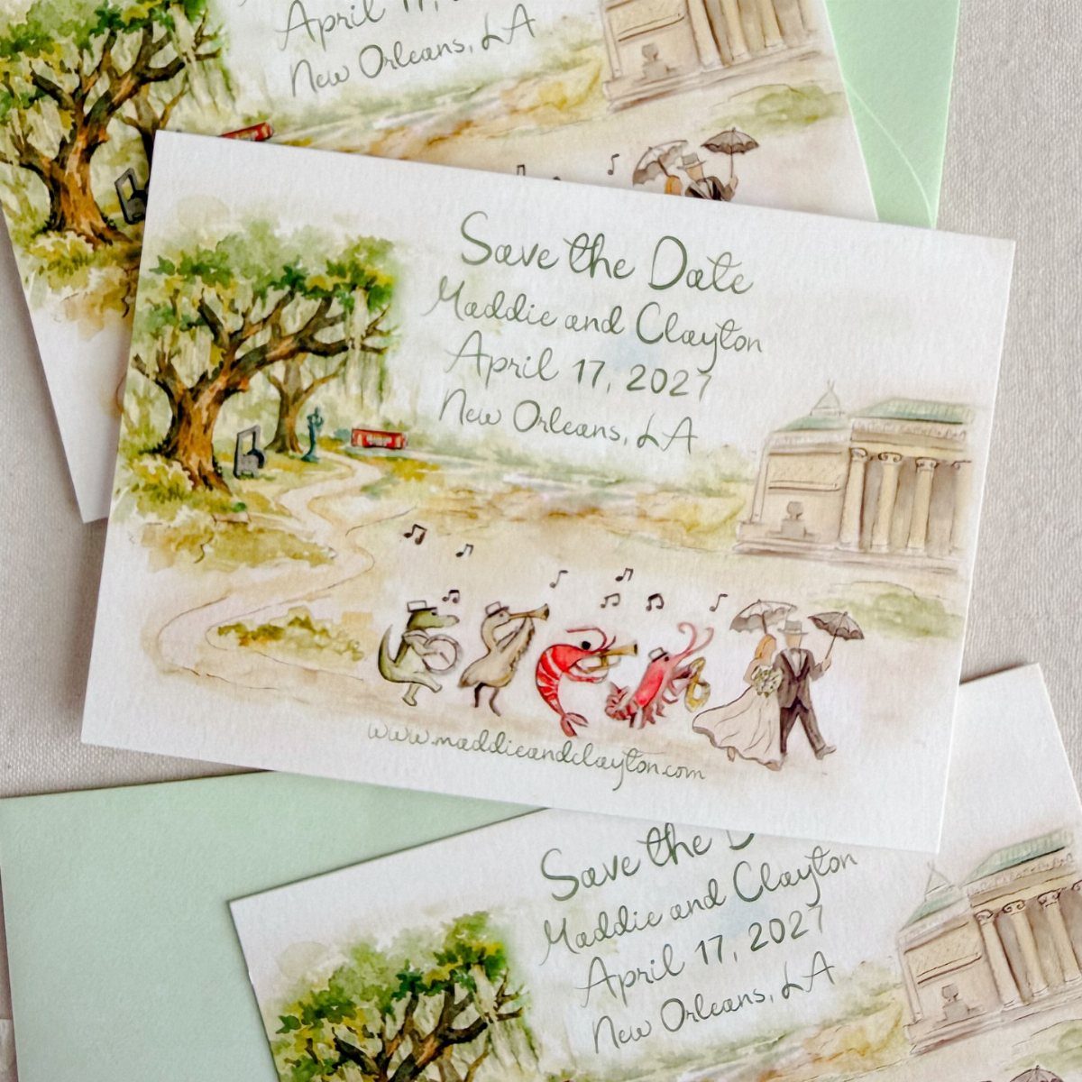 Watercolor save the date cards featuring a whimsical New Orleans city scene illustration.