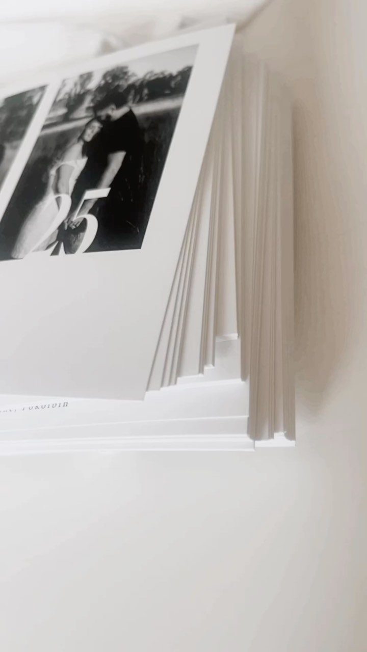 Stack of save the date cards featuring a black and white couple portrait.