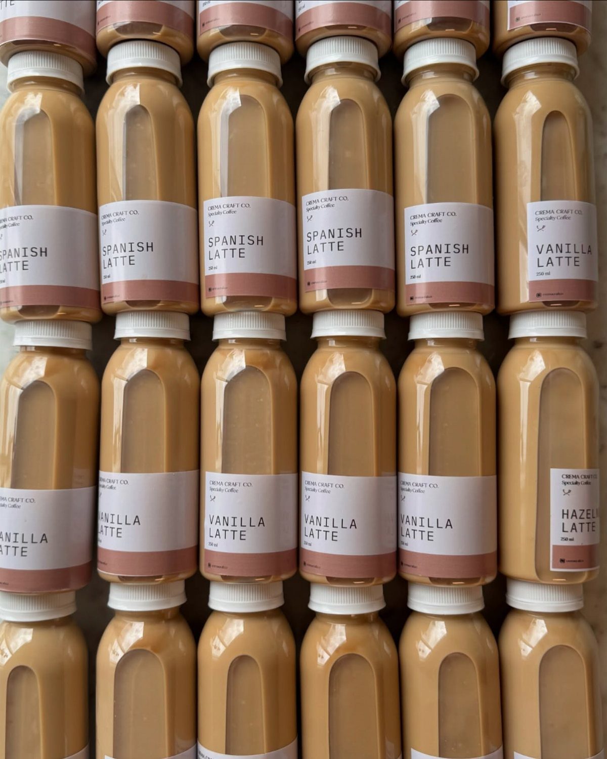 Rows of bottled coffee lattes in various flavors like vanilla and Spanish latte.