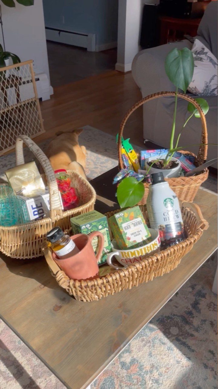 Wicker gift baskets filled with assorted prizes sitting on a wooden coffee table.