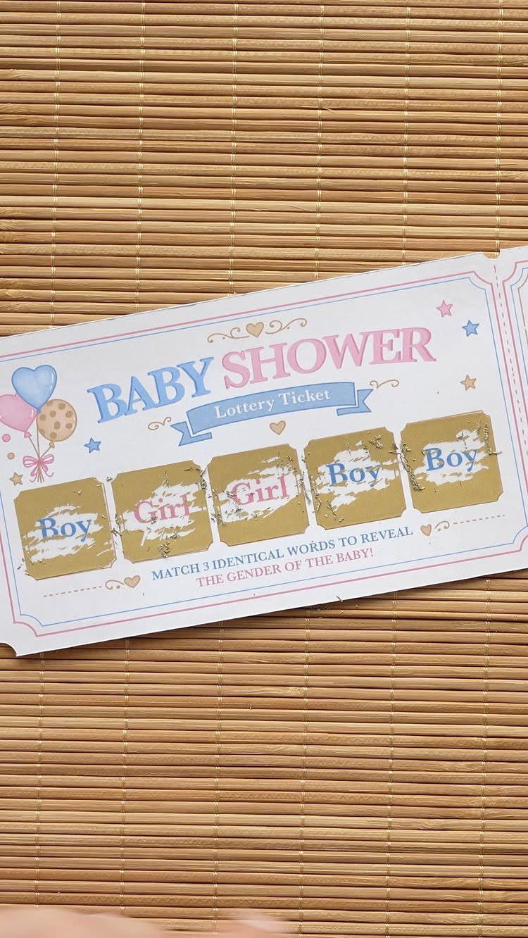 Baby shower lottery ticket with gold scratch-off panels on a bamboo mat