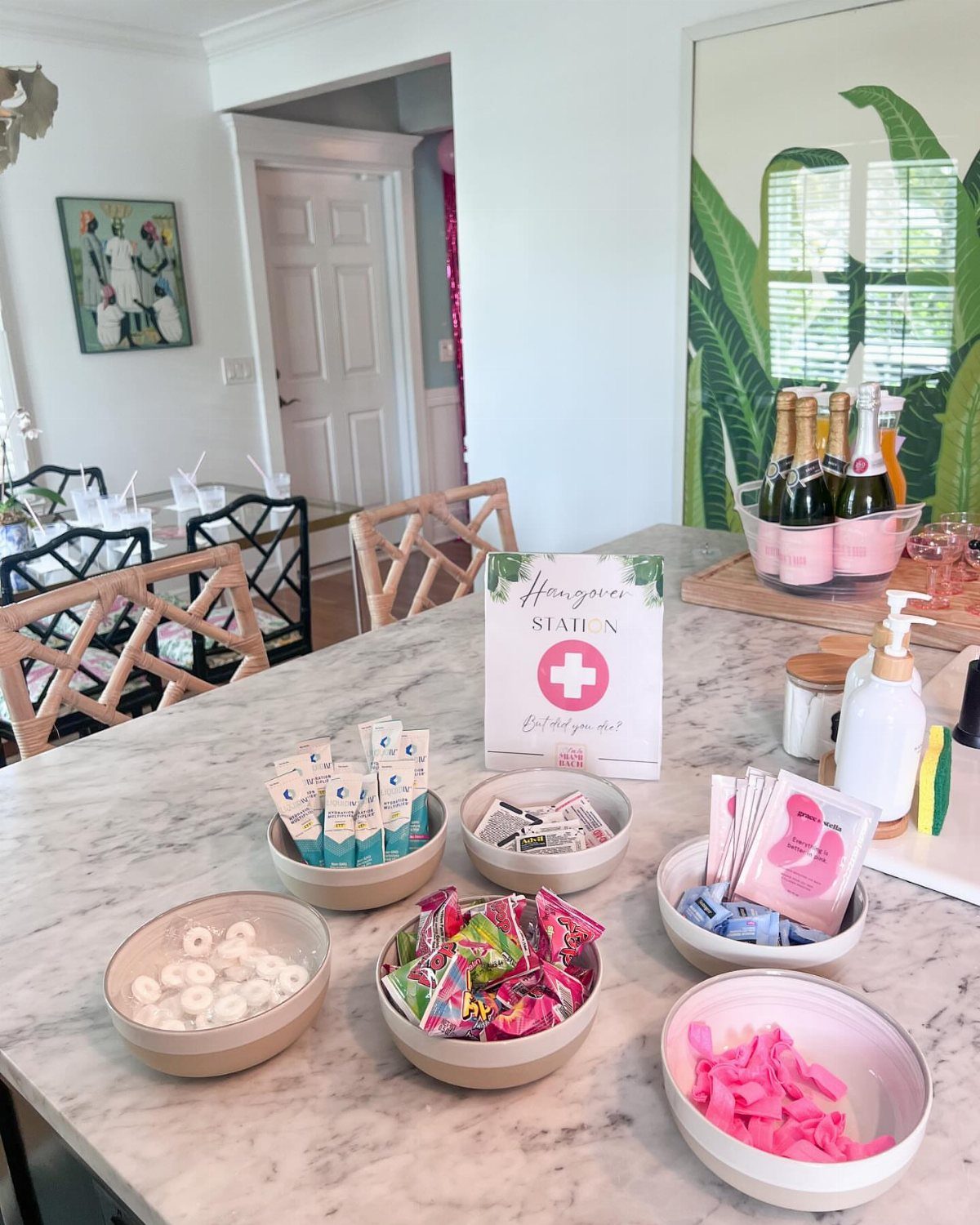 Hangover station on a marble counter with bowls of mints, candies, and packets.