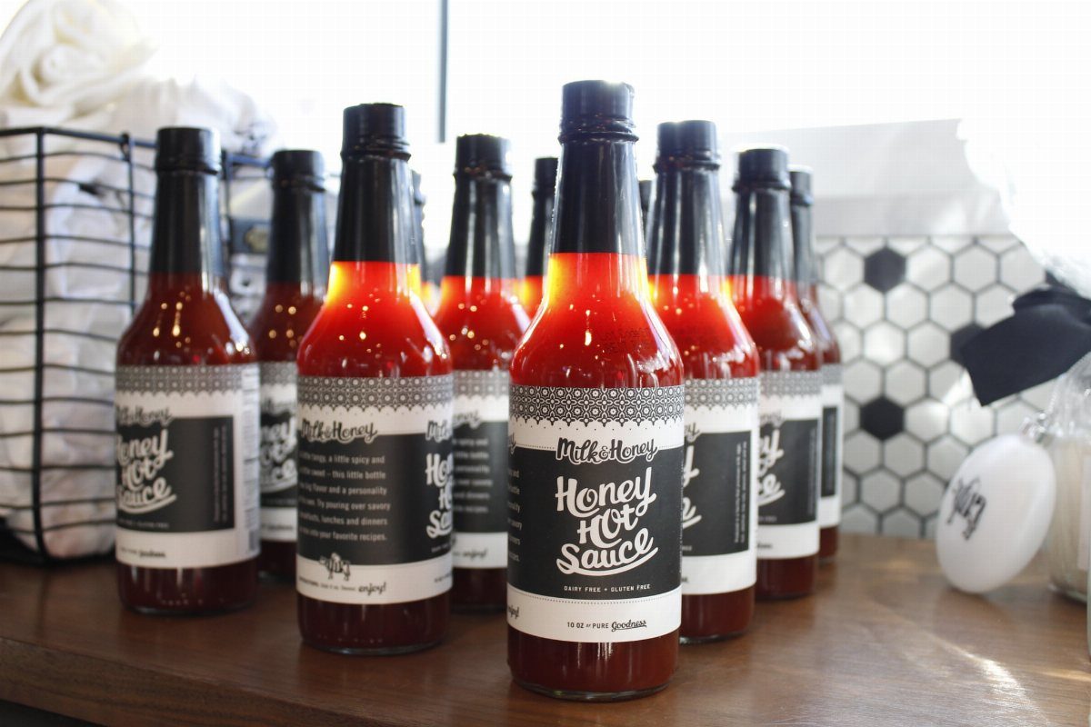 Small glass bottles of red honey hot sauce with black and white labels.