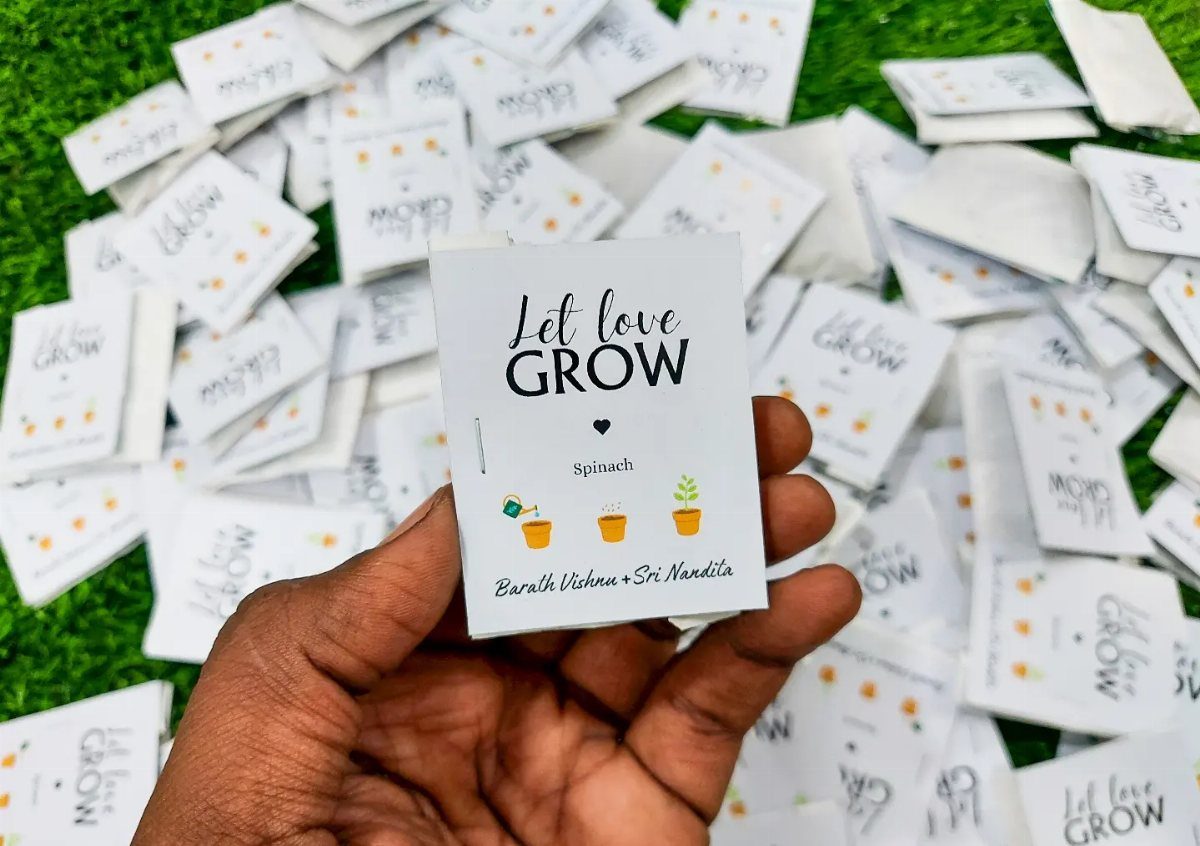 White seed packets with Let love GROW text scattered on green grass