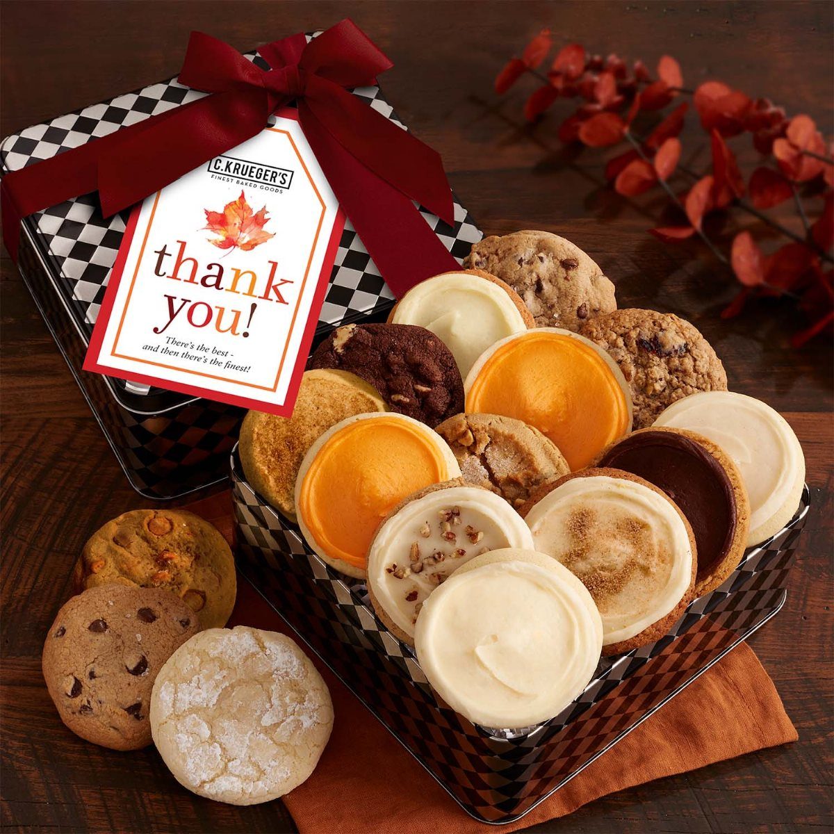 Assorted frosted and chocolate chip cookies in a checkered tin with thank you tag