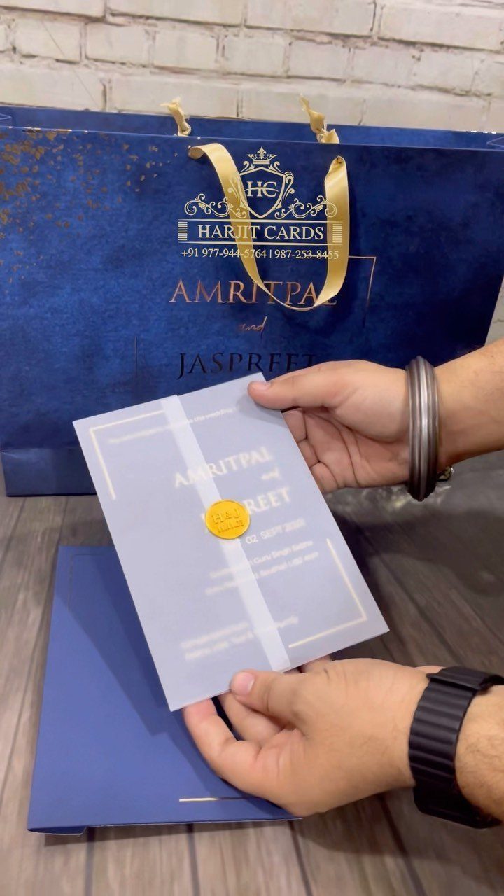 Vellum paper invitation with gold foil printing and a gold wax seal.