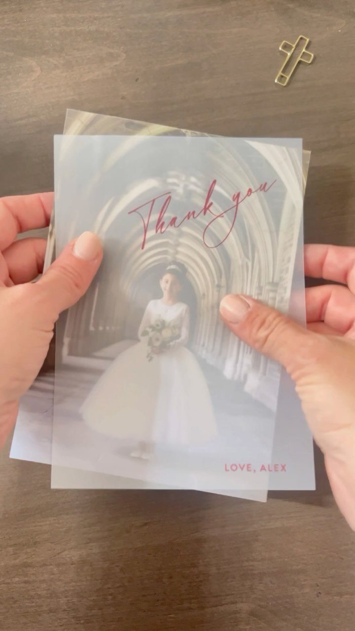 Translucent vellum overlay with red text over a wedding photo of a bride.