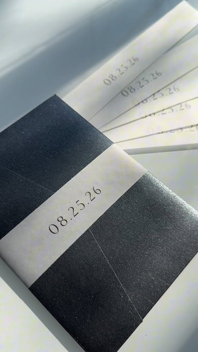 Translucent vellum belly band with date printed on a dark grey invitation envelope