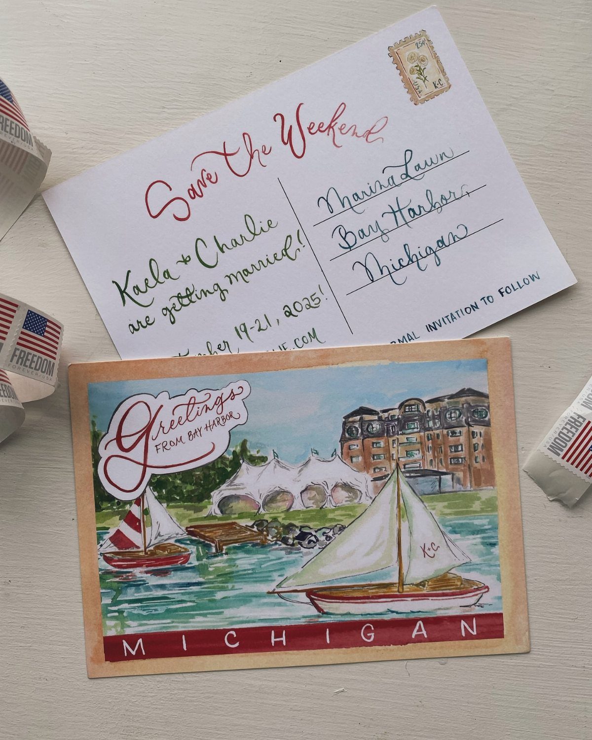 Handwritten save the date card and illustrated Michigan postcard with sailboats on water.