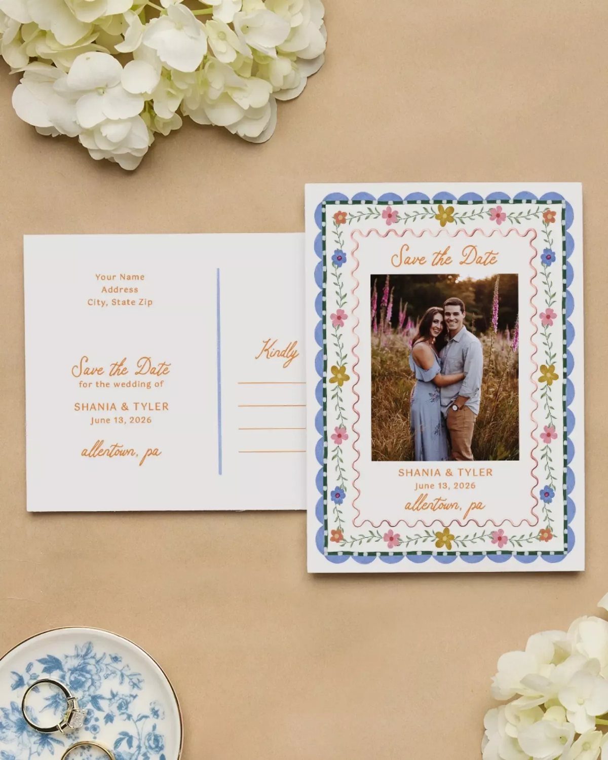 Save the date postcard with vintage typefaces, floral border, and couple's photo.