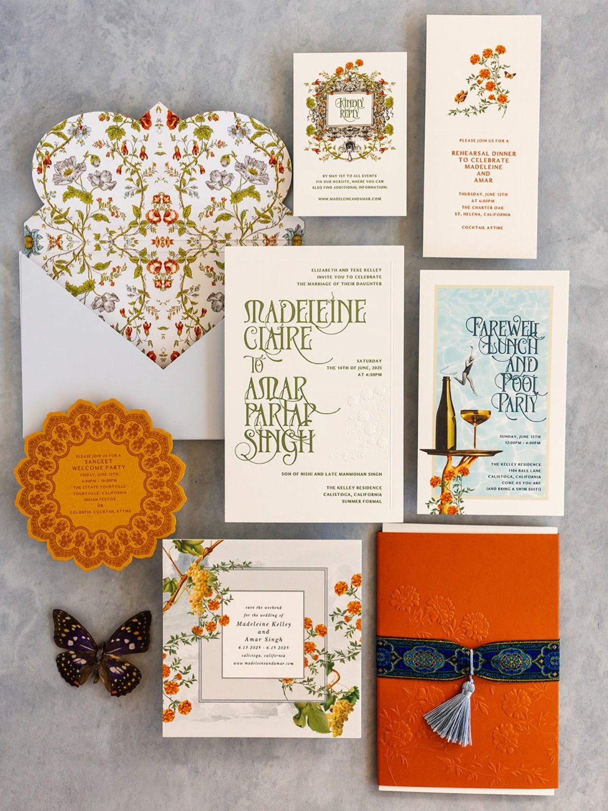 Wedding invitation suite with floral patterns and an orange card tied with blue ribbon.