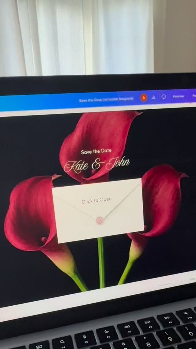 Laptop screen showing a digital save the date with red calla lilies.