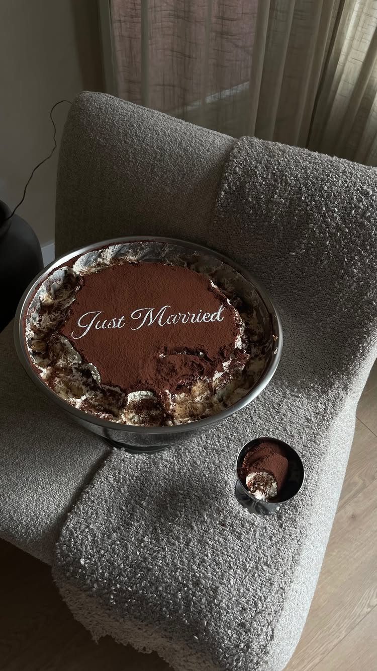 Tiramisu dessert in a glass bowl with Just Married written in white icing