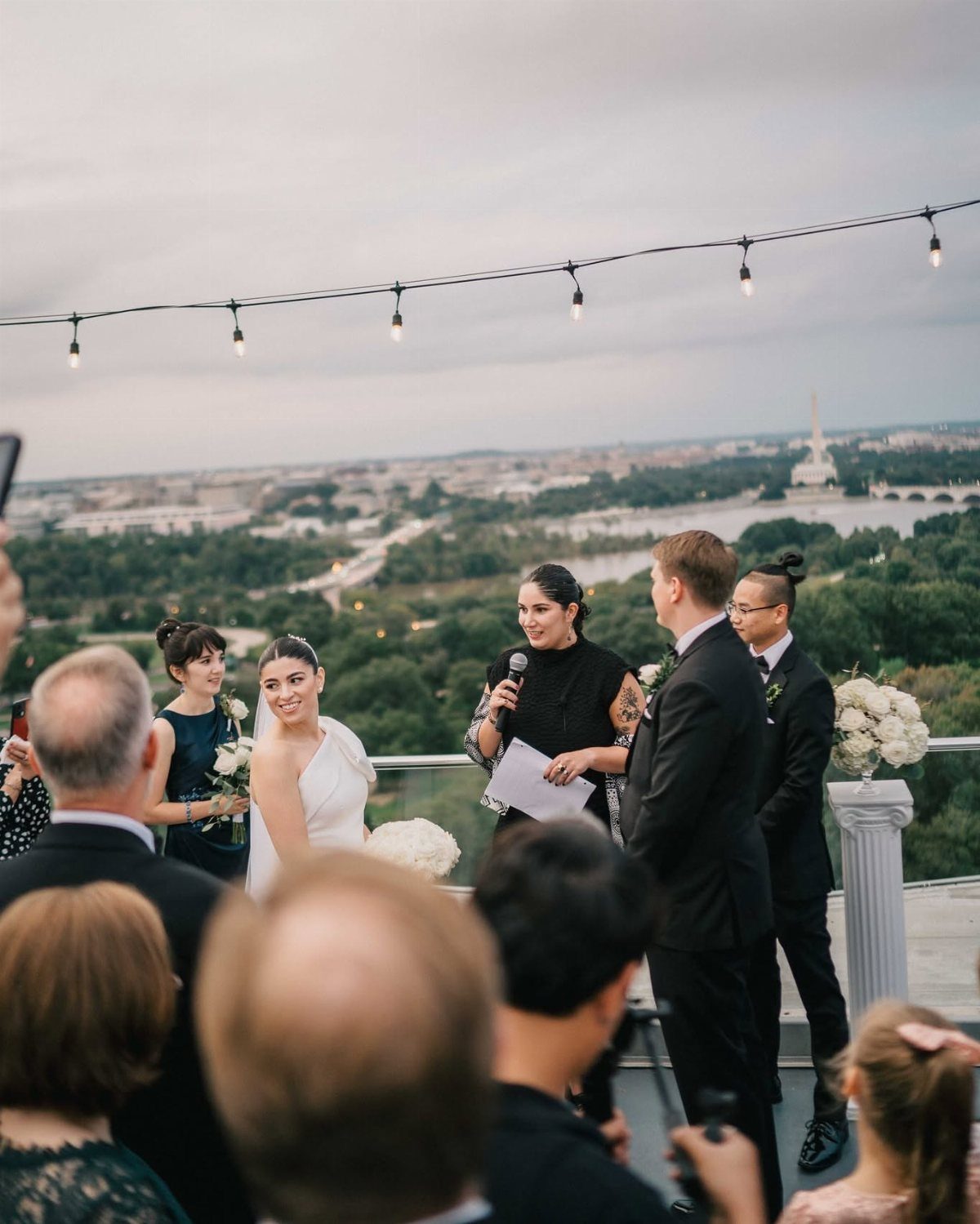 Wedding ceremony on a rooftop terrace overlooking the Washington DC city skyline.